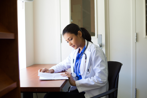 Medical student with stethoscope and books