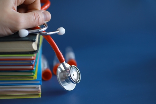 Stethoscope on stack of medical books